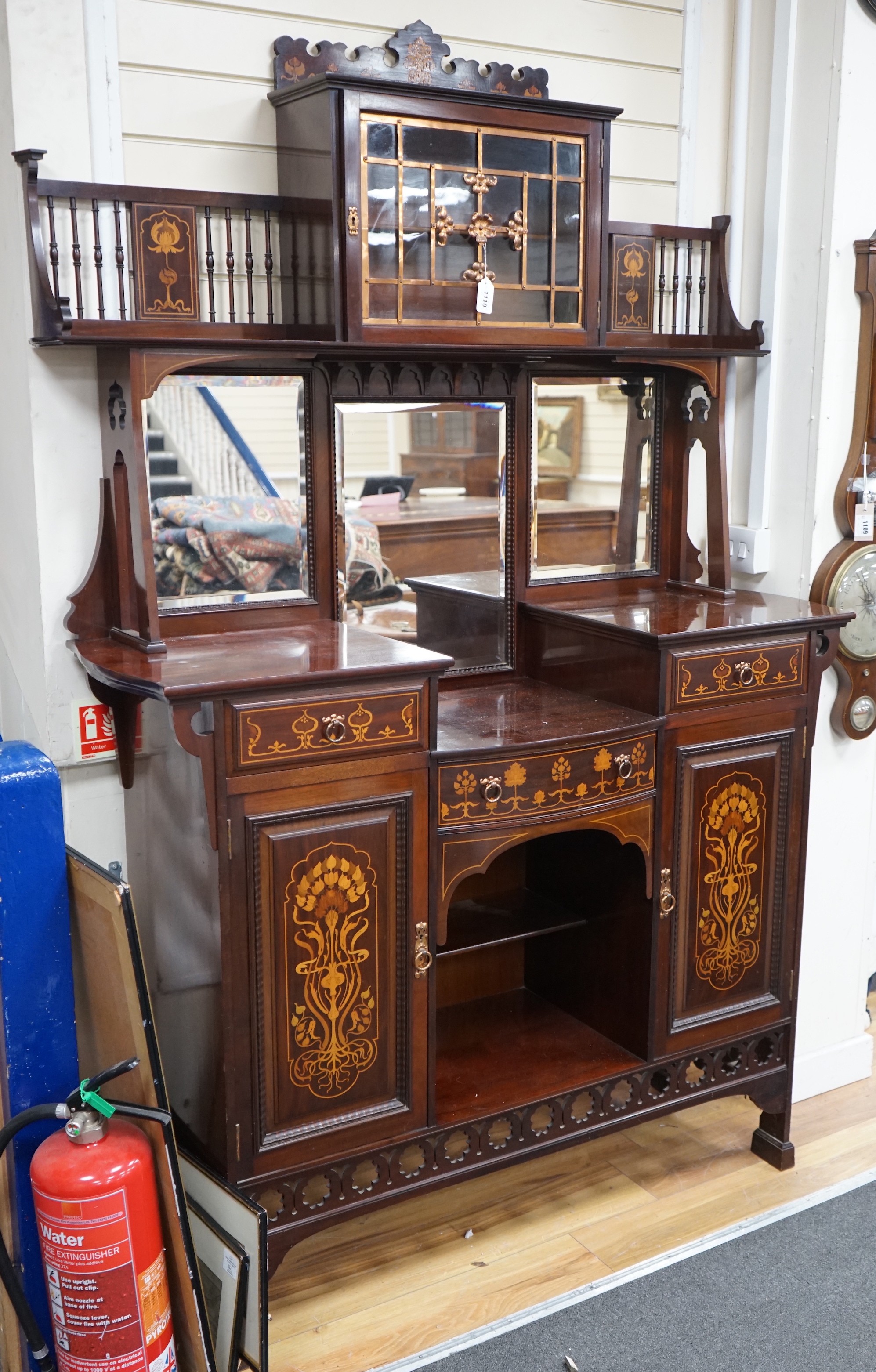 An Arts & Crafts marquetry inlaid mahogany amaryllis pattern side cabinet, in the manner of Shapland & Petter